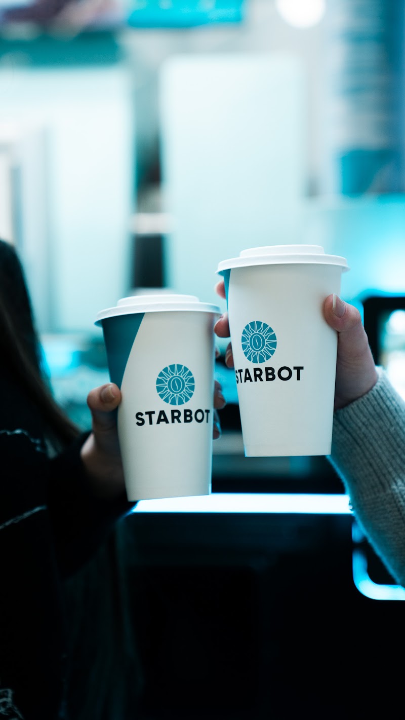 Customer collecting coffee from Starbot